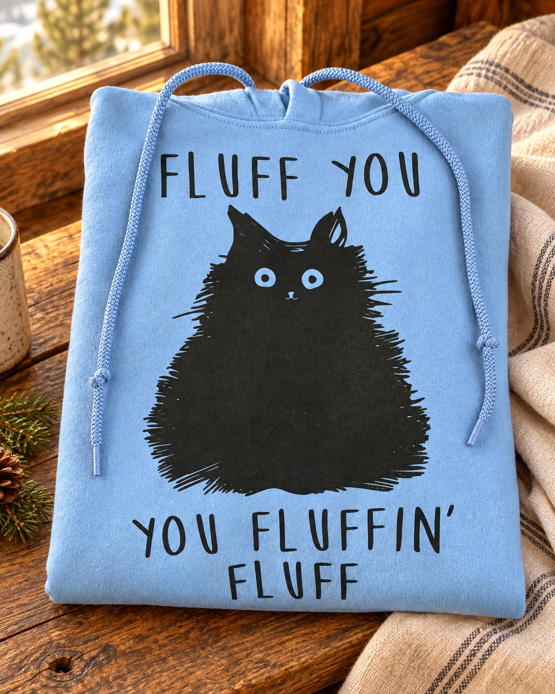 Fluff You Hoodie or T-Shirt displayed in a warm styled setting